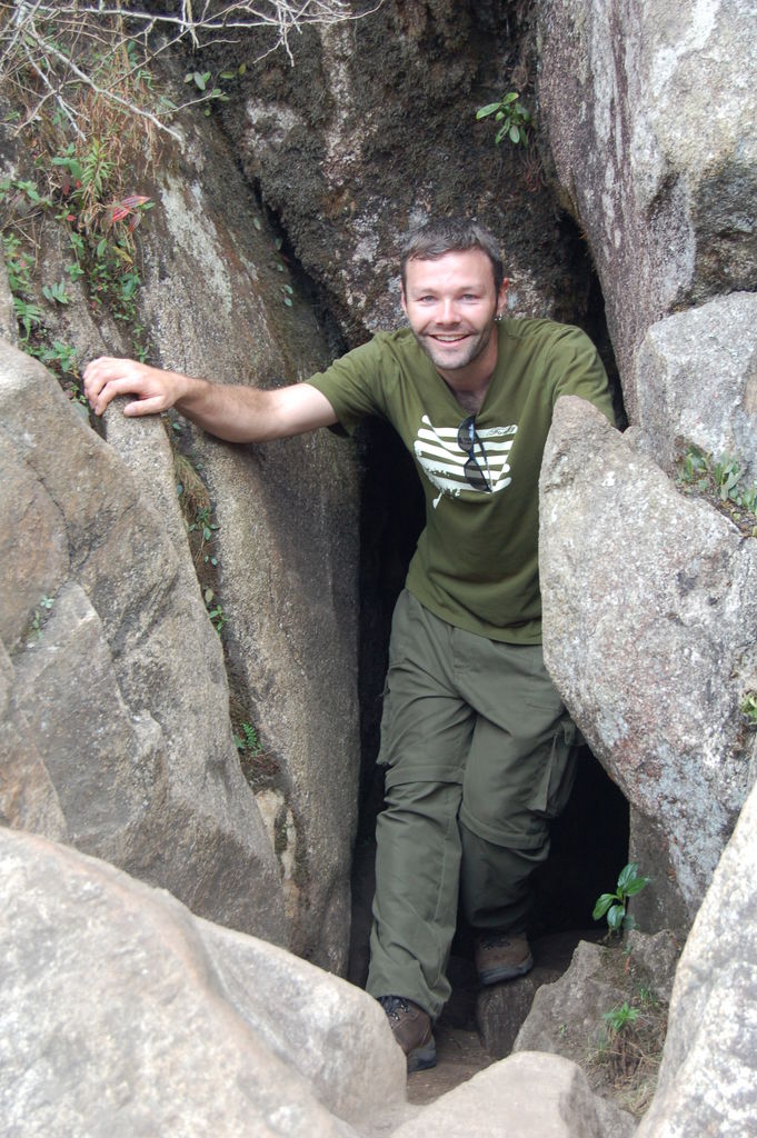 At the mouth of a little tunnel to get to the top of Huayna Picchu